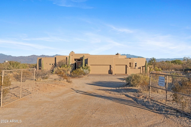 pueblo revival-style home with a mountain view and a garage