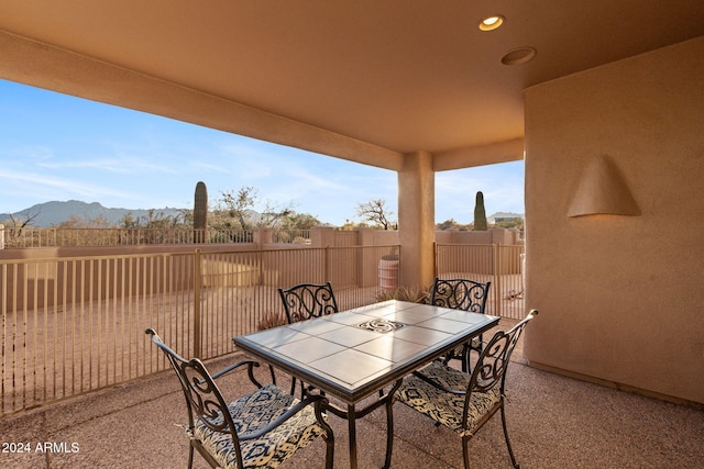 view of patio / terrace with a mountain view and a balcony