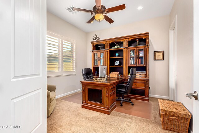 office space featuring ceiling fan and light colored carpet