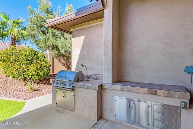 view of patio / terrace featuring grilling area and an outdoor kitchen