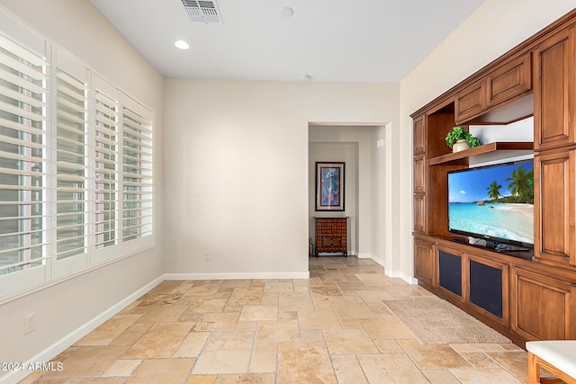 unfurnished living room featuring a wealth of natural light