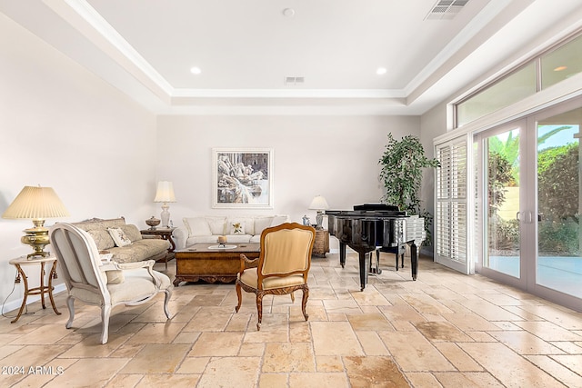 living room with a raised ceiling and french doors