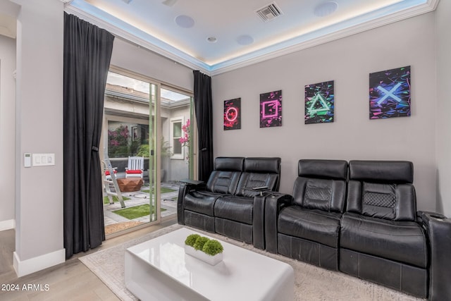 cinema room featuring light wood-type flooring and crown molding