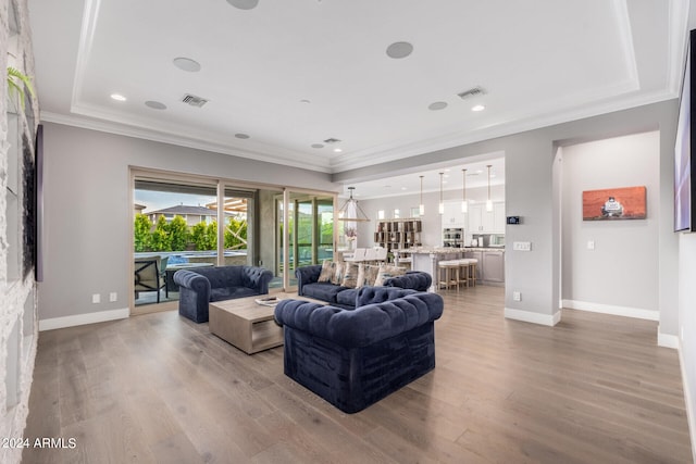 living room with ornamental molding and light wood-type flooring