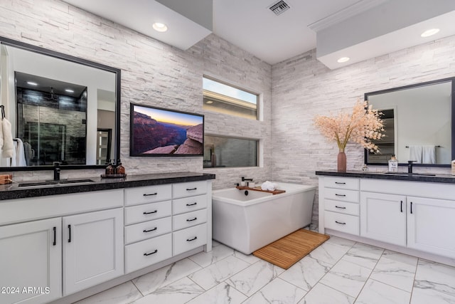 bathroom featuring tile walls, vanity, and separate shower and tub