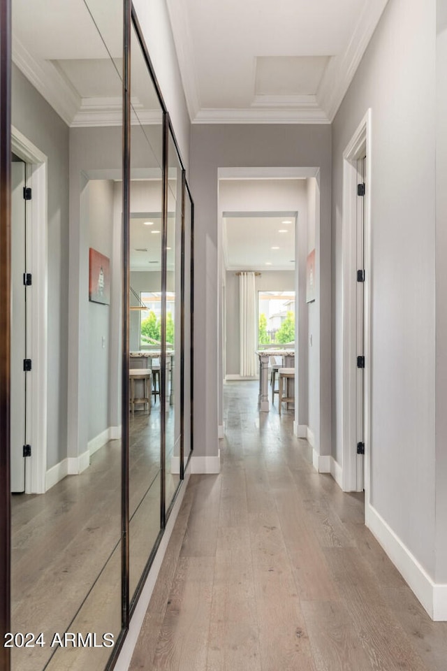 hall with hardwood / wood-style floors and crown molding