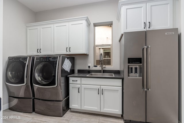 laundry room featuring cabinets, sink, and independent washer and dryer