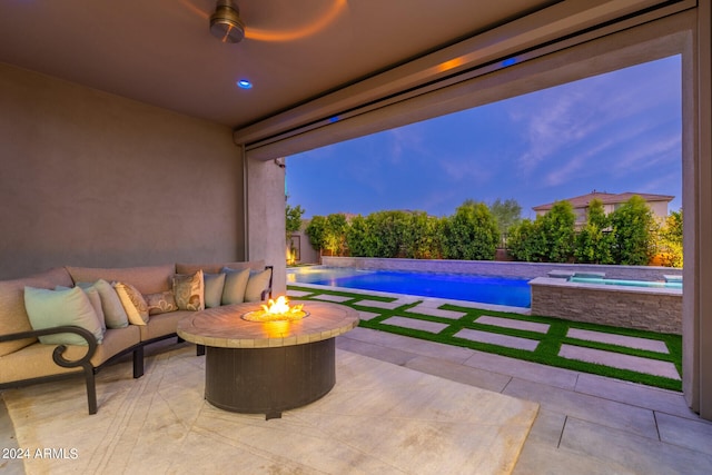 patio terrace at dusk with a pool with hot tub