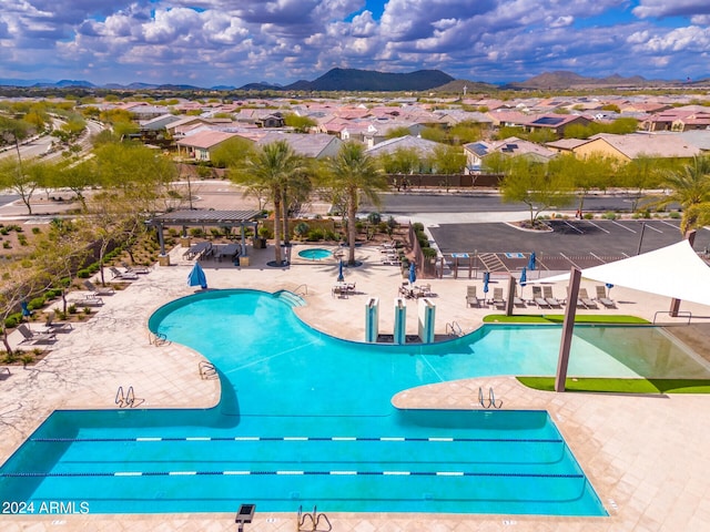 view of pool with a mountain view and a patio area