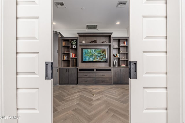 interior space with dark brown cabinetry, parquet flooring, and crown molding