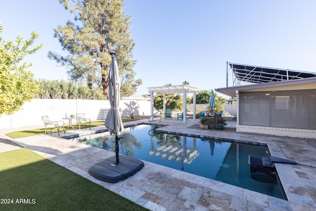 view of swimming pool featuring a pergola, a patio area, and a sunroom