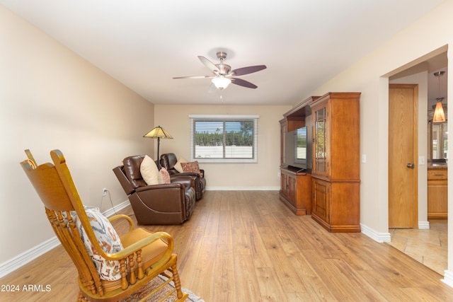 sitting room with light hardwood / wood-style floors and ceiling fan