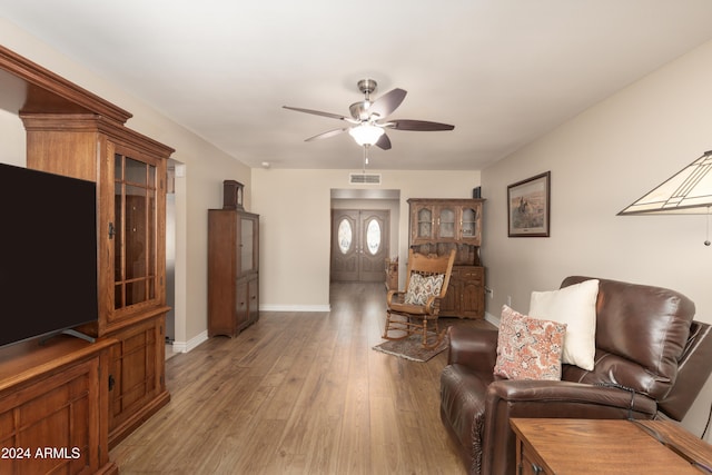 living room featuring hardwood / wood-style floors and ceiling fan