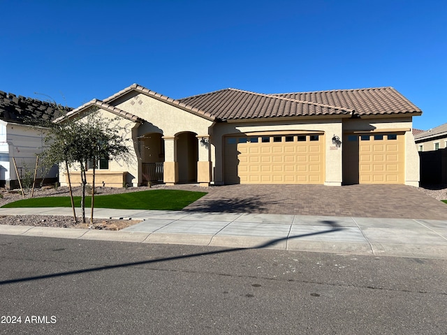 mediterranean / spanish home featuring a garage