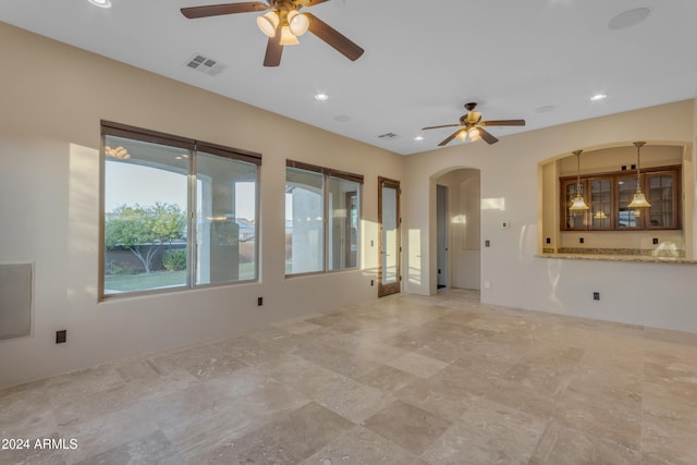 unfurnished living room with ceiling fan