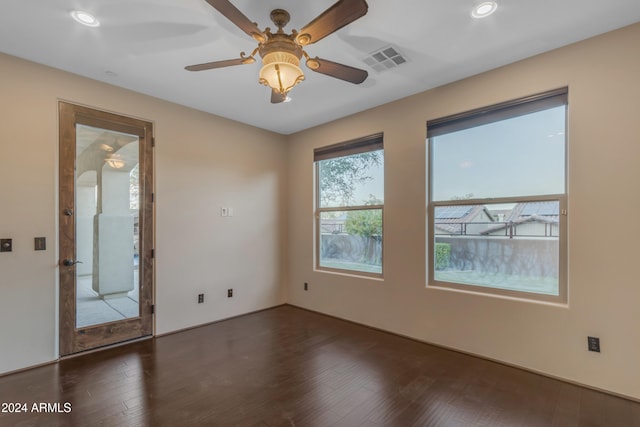 empty room featuring ceiling fan and dark hardwood / wood-style floors