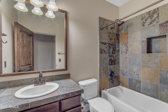 full bathroom with tiled shower / bath combo, toilet, and vanity