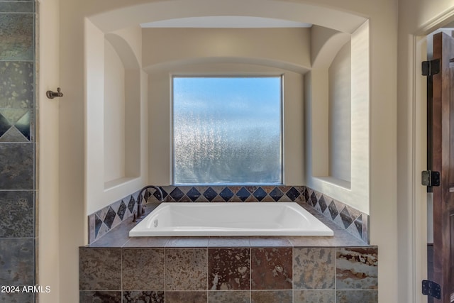 bathroom with tiled tub