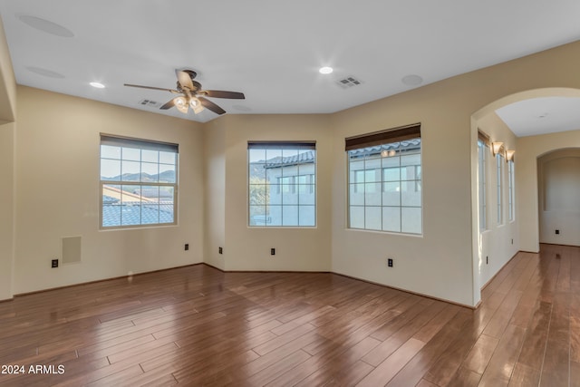 empty room with hardwood / wood-style floors and ceiling fan