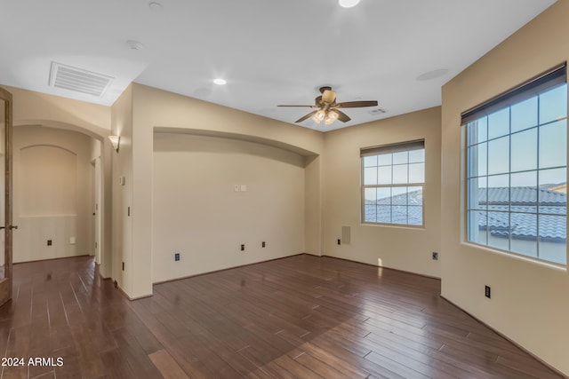 unfurnished room with ceiling fan and dark hardwood / wood-style flooring