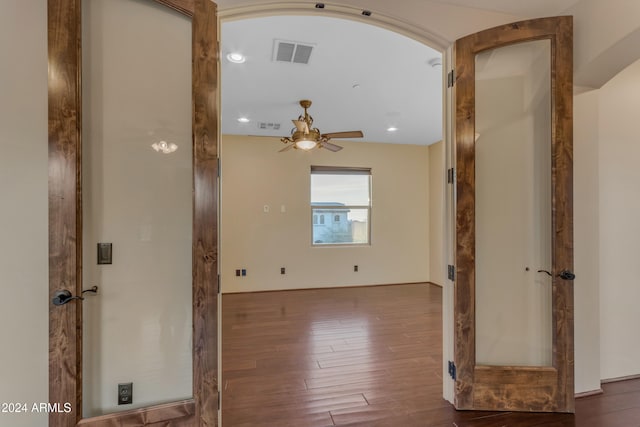 corridor with hardwood / wood-style floors