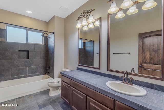 full bathroom featuring toilet, vanity, and tiled shower / bath