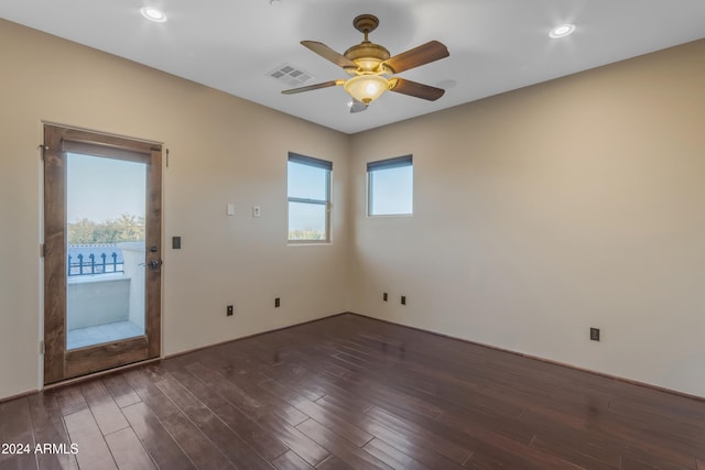 spare room with ceiling fan and dark wood-type flooring