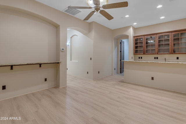 empty room featuring ceiling fan and light hardwood / wood-style floors