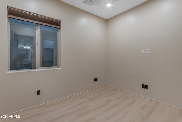 empty room with light hardwood / wood-style flooring