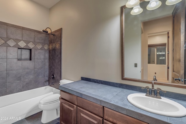 full bathroom with tile patterned flooring, vanity, toilet, and tiled shower / bath