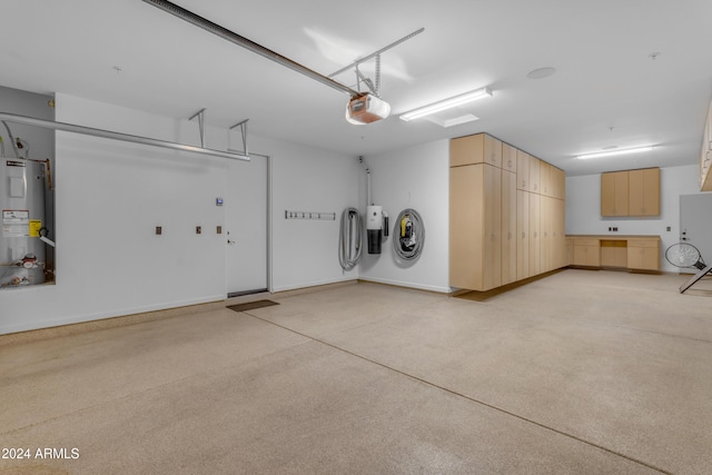 garage featuring a garage door opener and water heater