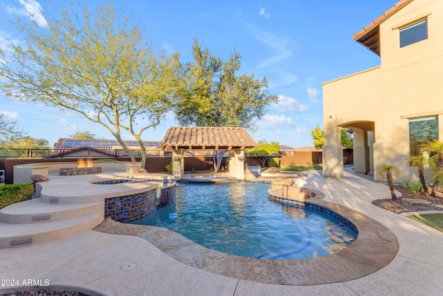 view of swimming pool with a patio area and an in ground hot tub