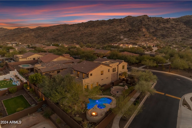 aerial view at dusk featuring a mountain view