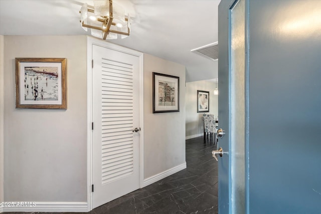 hall featuring an inviting chandelier