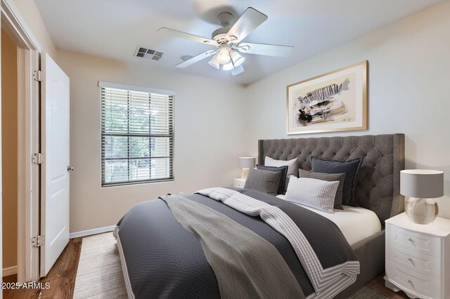 2862 E Megan St, Gilbert, AZ 85295 - bedroom with dark wood-style flooring, baseboards, and a ceiling fan