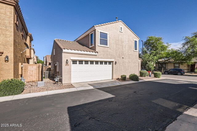 2862 E Megan St, Gilbert, AZ 85295 - view of property exterior featuring stucco siding, a garage, and a tiled roof