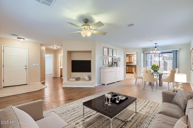 2862 E Megan St, Gilbert, AZ 85295 - living area with light wood finished floors, ceiling fan, baseboards, and a chandelier
