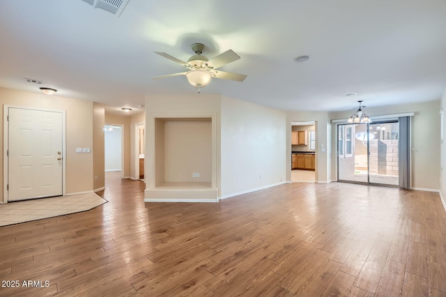 2862 E Megan St, Gilbert, AZ 85295 - unfurnished living room featuring light wood finished floors, a ceiling fan, baseboards, and a chandelier