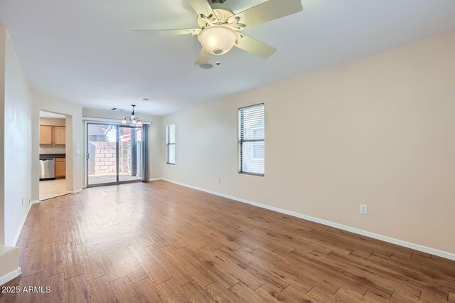 2862 E Megan St, Gilbert, AZ 85295 - unfurnished living room with a chandelier, baseboards, light wood-type flooring, and a ceiling fan