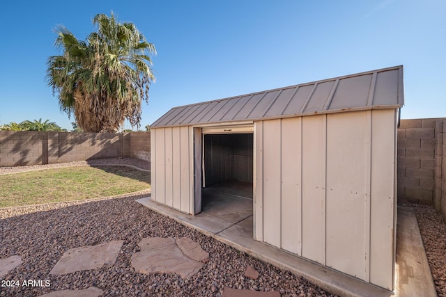 view of outbuilding featuring a yard