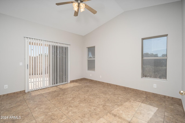 empty room featuring ceiling fan, lofted ceiling, and light tile patterned floors