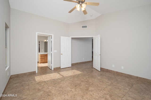 unfurnished bedroom with ceiling fan, light tile patterned floors, and high vaulted ceiling