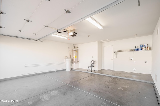 garage featuring a garage door opener and water heater