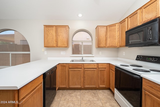 kitchen featuring black appliances, kitchen peninsula, sink, and light tile patterned floors