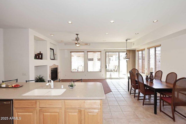 kitchen featuring dishwasher, light brown cabinets, sink, ceiling fan, and light tile patterned floors