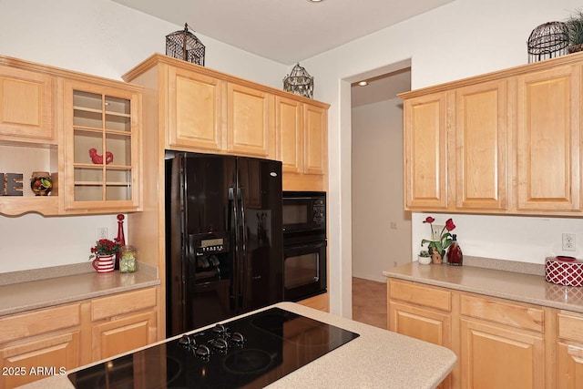 kitchen with light brown cabinetry and black appliances