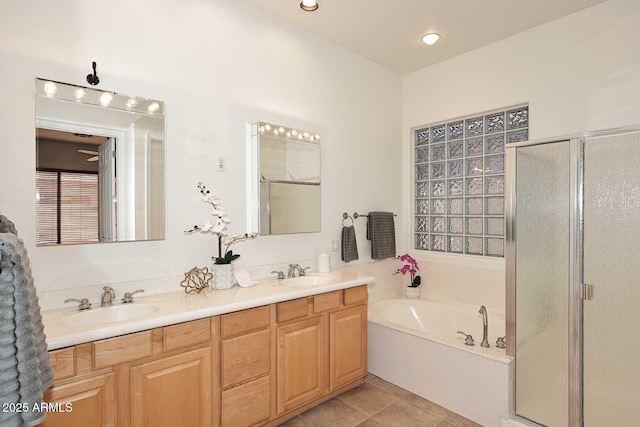 bathroom with tile patterned flooring, vanity, and independent shower and bath