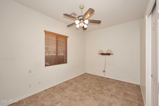 tiled spare room with ceiling fan