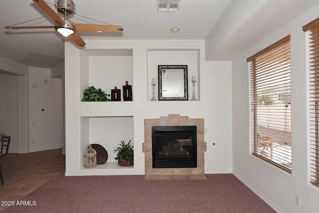 unfurnished living room with a fireplace, carpet, and ceiling fan