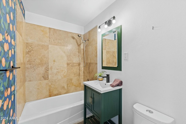 full bathroom featuring vanity, tiled shower / bath combo, and toilet